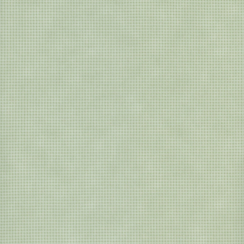 Mottled sage green fabric with a small, repeating, dotted texture throughout