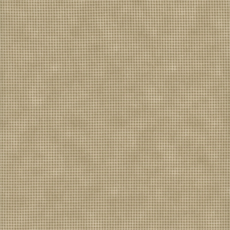 Mottled light tan fabric with a small, repeating, dotted texture throughout