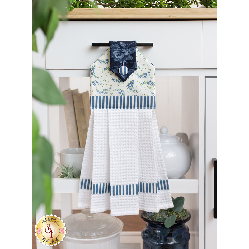 The completed Shoreline Hanging Towel in cream, hung from a kitchen cart drawer handle and staged with coordinating decor.