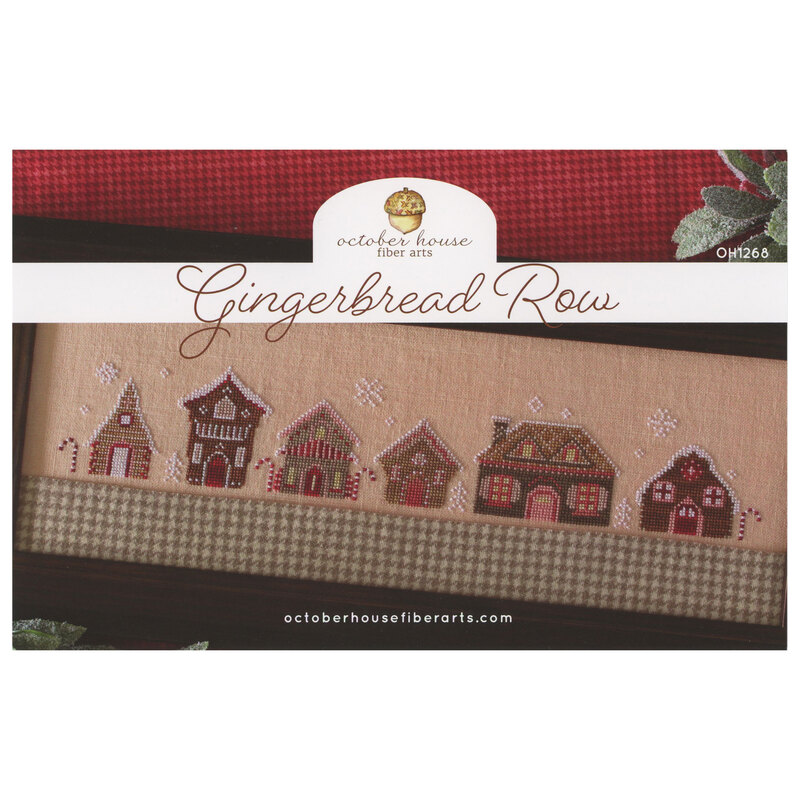 front of Gingerbread Row cross stitch pattern displaying finished cross stitch in a black frame