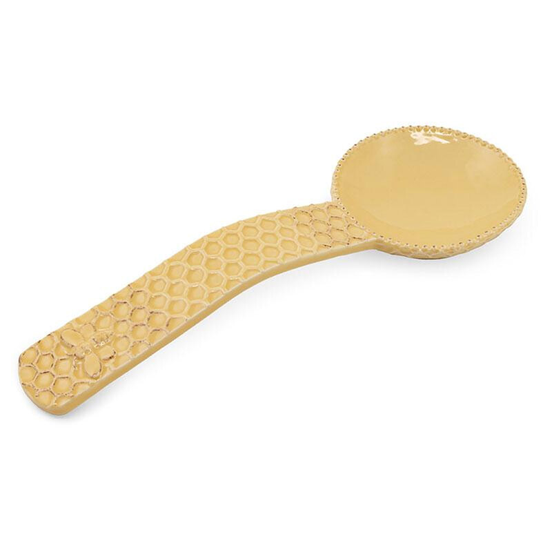 photo of honeycomb spoon rest on a white background