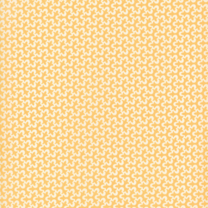 Fabric with a geometric fleur de lis pattern in white and golden yellow.