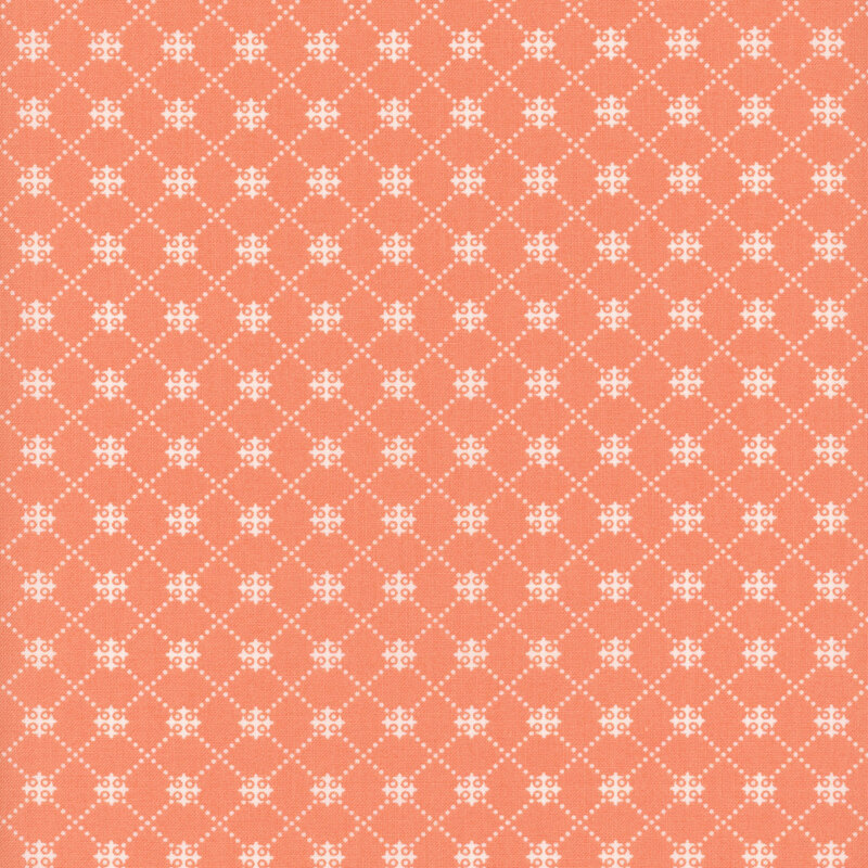 Peachy pink fabric with a white dotted trellis pattern.
