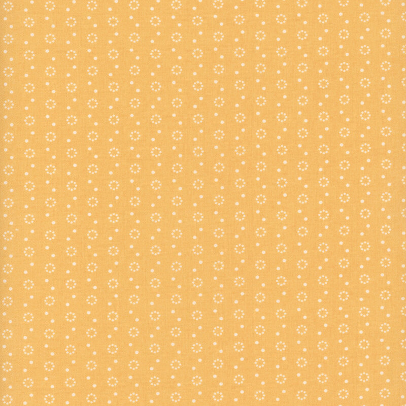 Golden yellow fabric with polka dot and dot circle motifs in white.