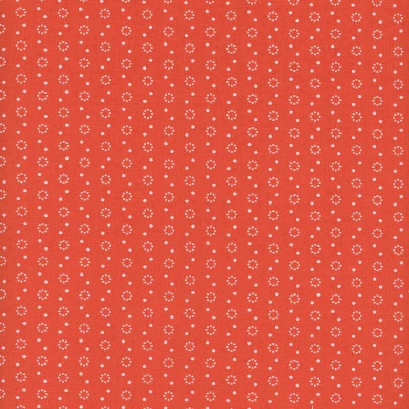 Bright red fabric with polka dot and dot circle motifs in white.