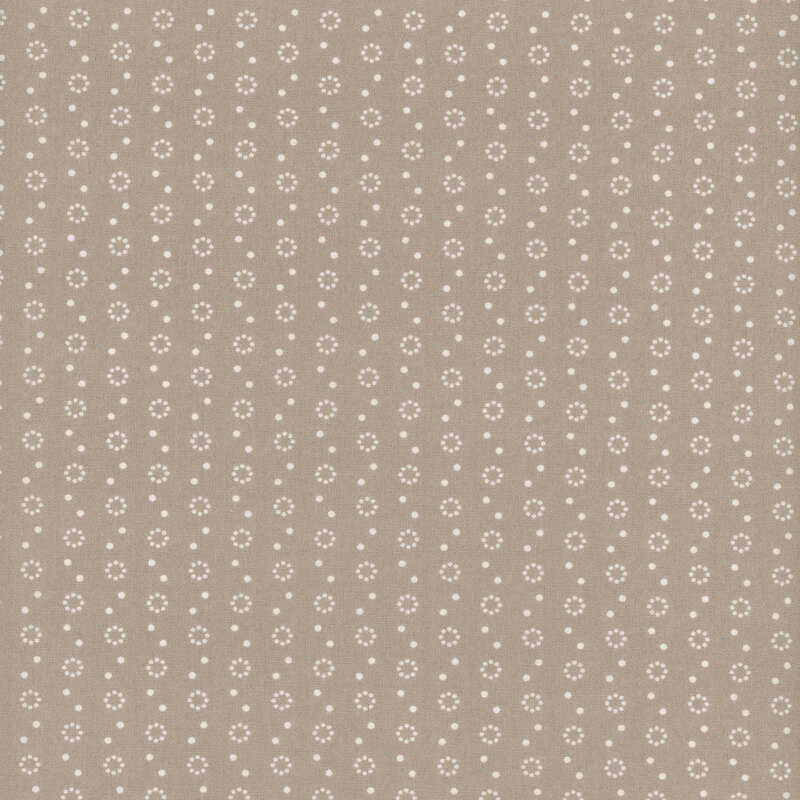 Warm gray fabric with polka dot and dot circle motifs in white.