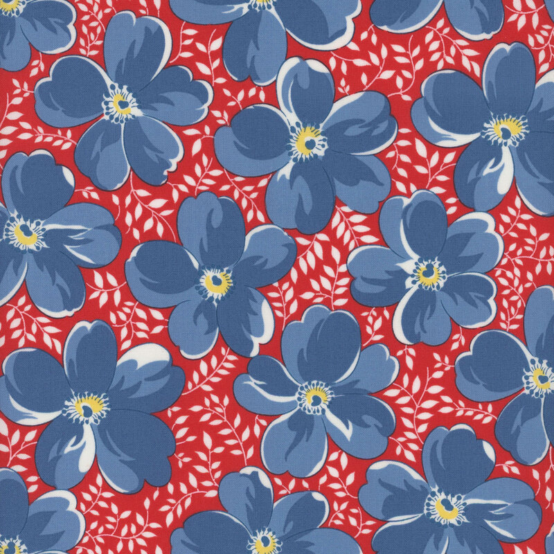 Bright red fabric with small white leaves and large blue flowers throughout