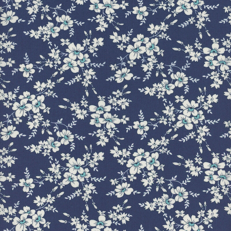 Dark navy blue fabric with clusters of white flowers with white leaves