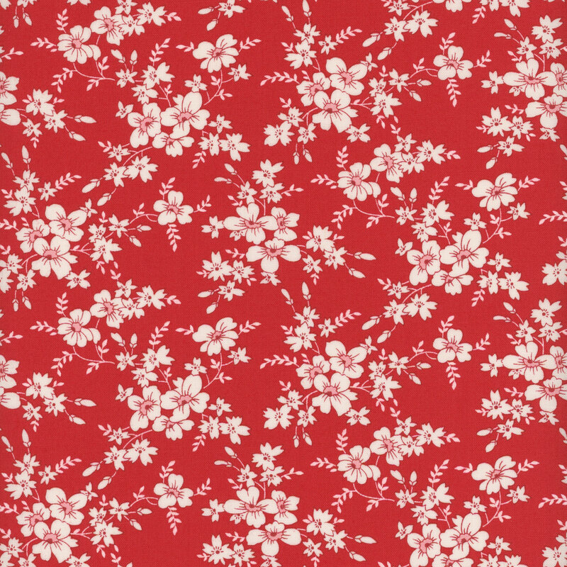 Bright red fabric with clusters of white flowers and white leaves throughout