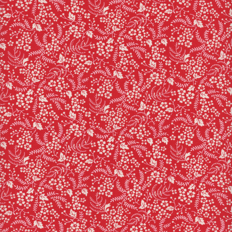 Bright red fabric with clusters of small white flowers and white vines with leaves throughout