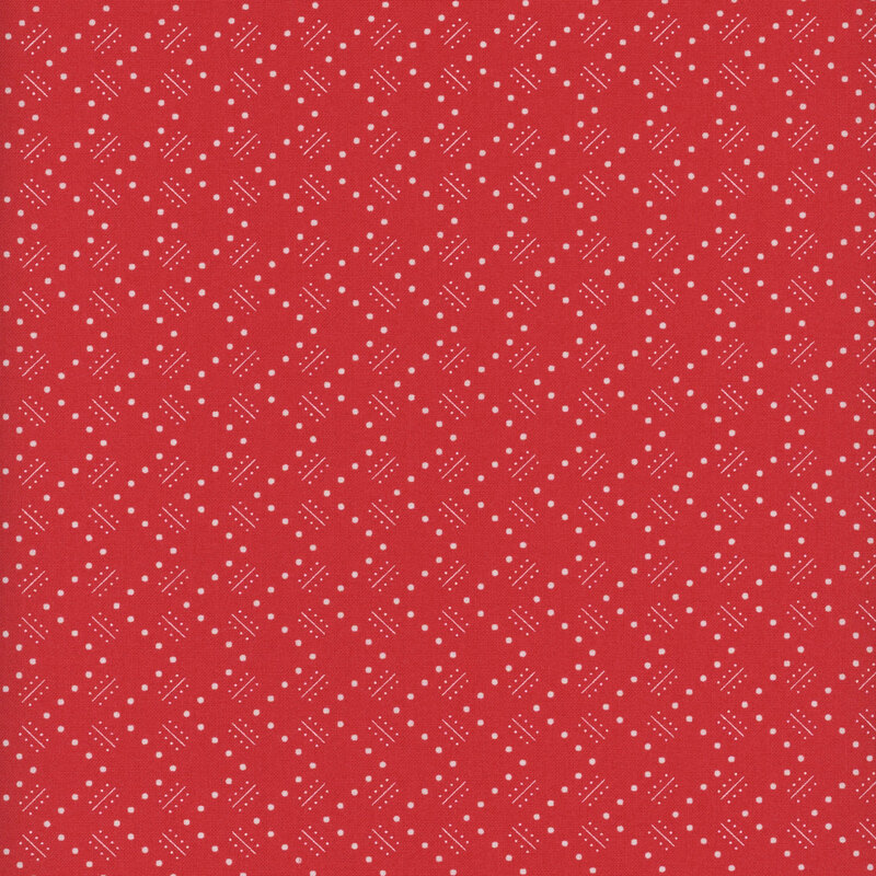 Bright red fabric with white dotted zig-zags and geometric shapes throughout
