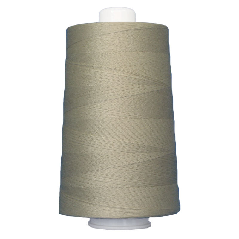 Cone spool of light tan thread, isolated on a white background