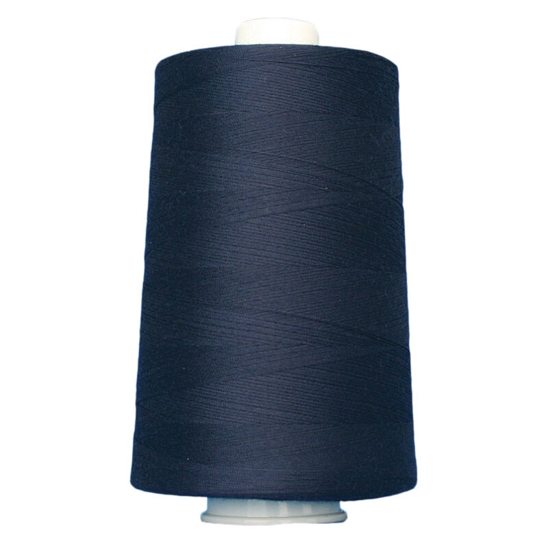 Large cone spool of dark navy blue thread on a white background