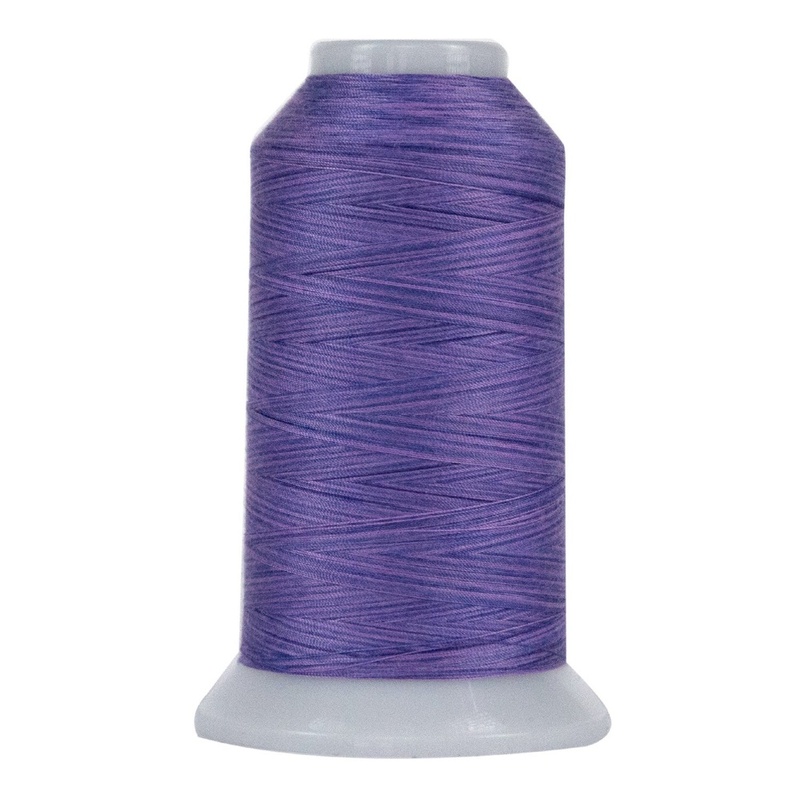 Spool of variegated wisteria purple thread, isolated on a white background.