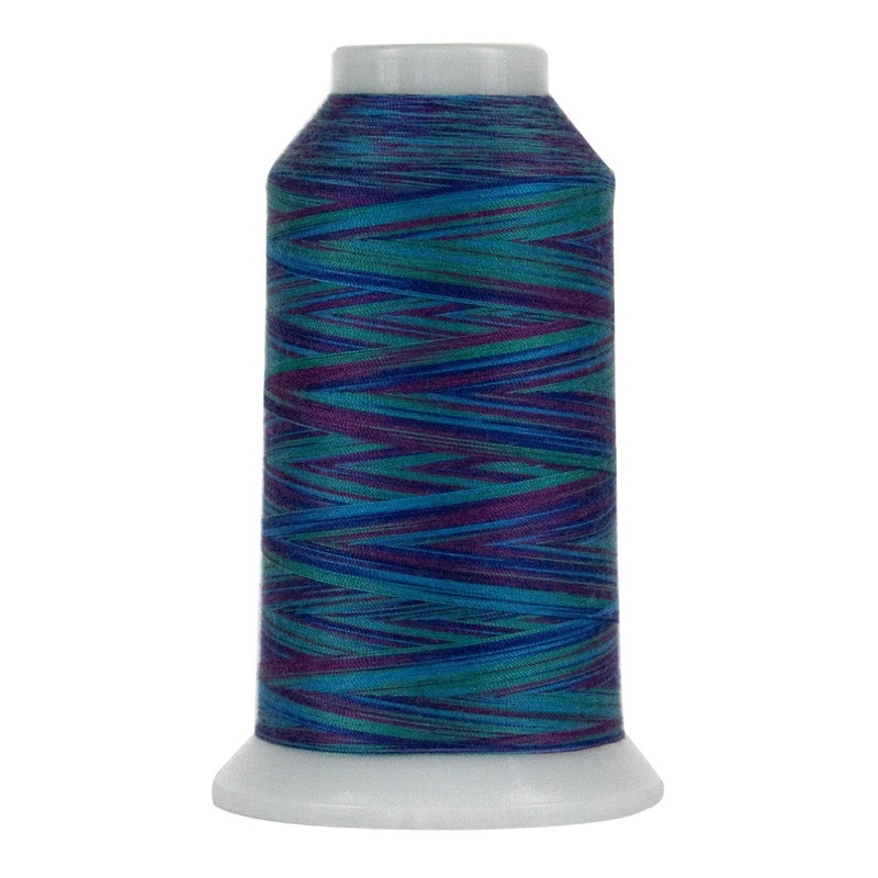 Spool of blue, green, and purple variegated thread, isolated on a white background.