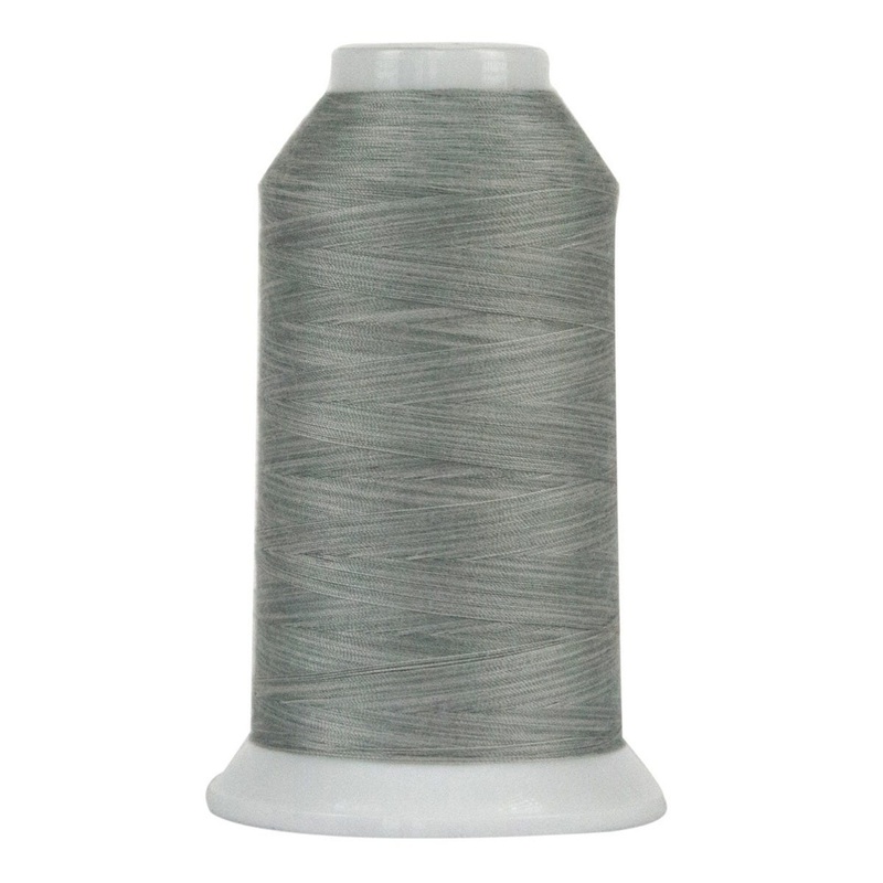 Spool of silvery gray thread, isolated on a white background.