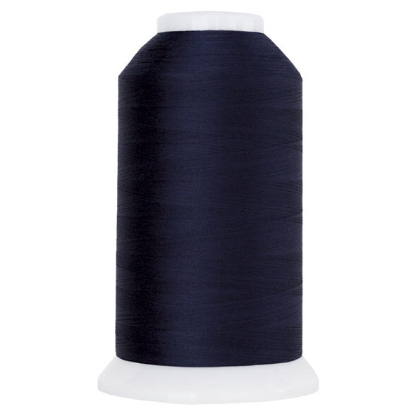 Dark navy blue spool of thread, isolated on a white background.