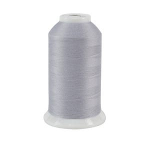 Silvery gray spool of thread, isolated on a white background.