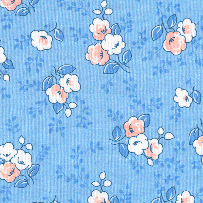 Blue fabric with tossed peach and white flowers and dark blue leaves and vines in the background