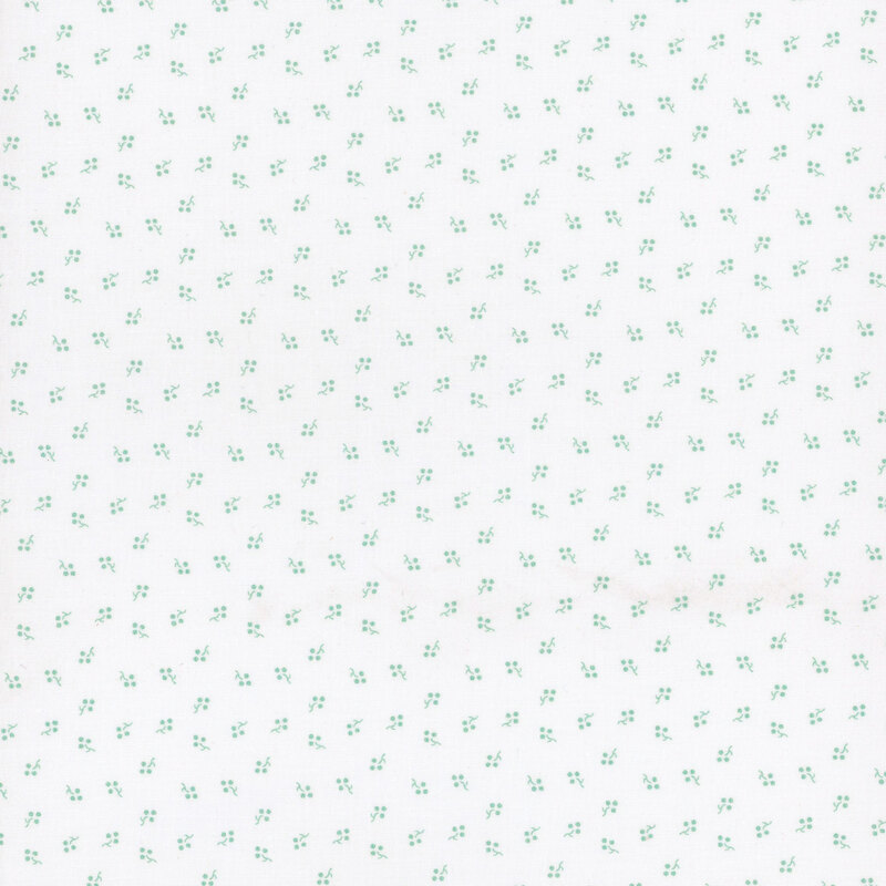 White fabric with small, teal, ditsy sprigs
