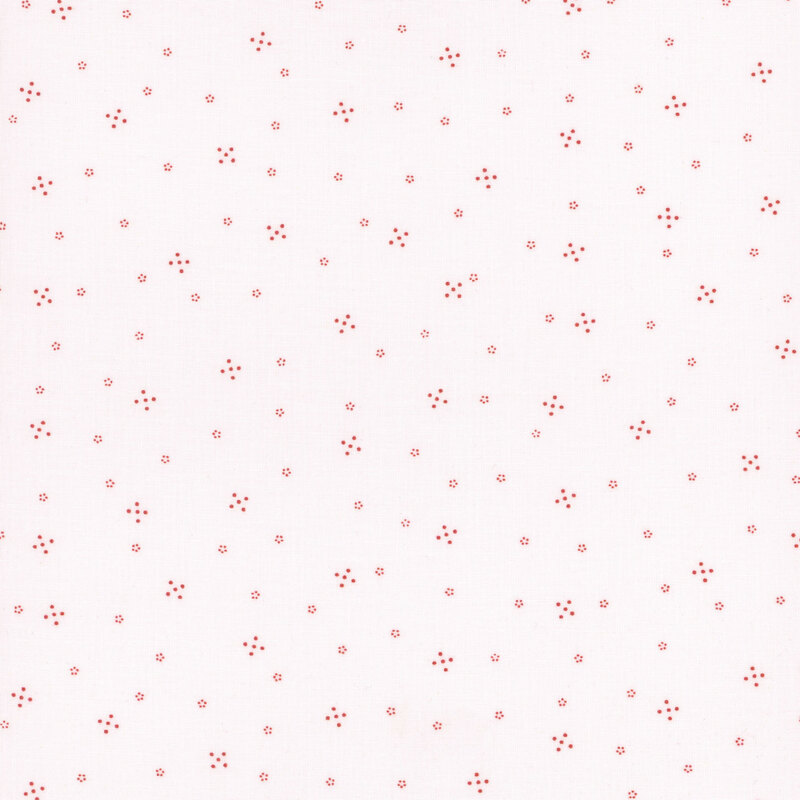 White fabric with small red ditsy dotted shapes and tiny florals throughout