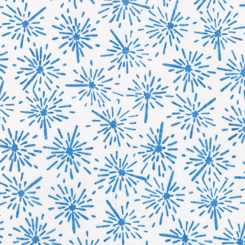 White batik fabric with a blue firework and star pattern