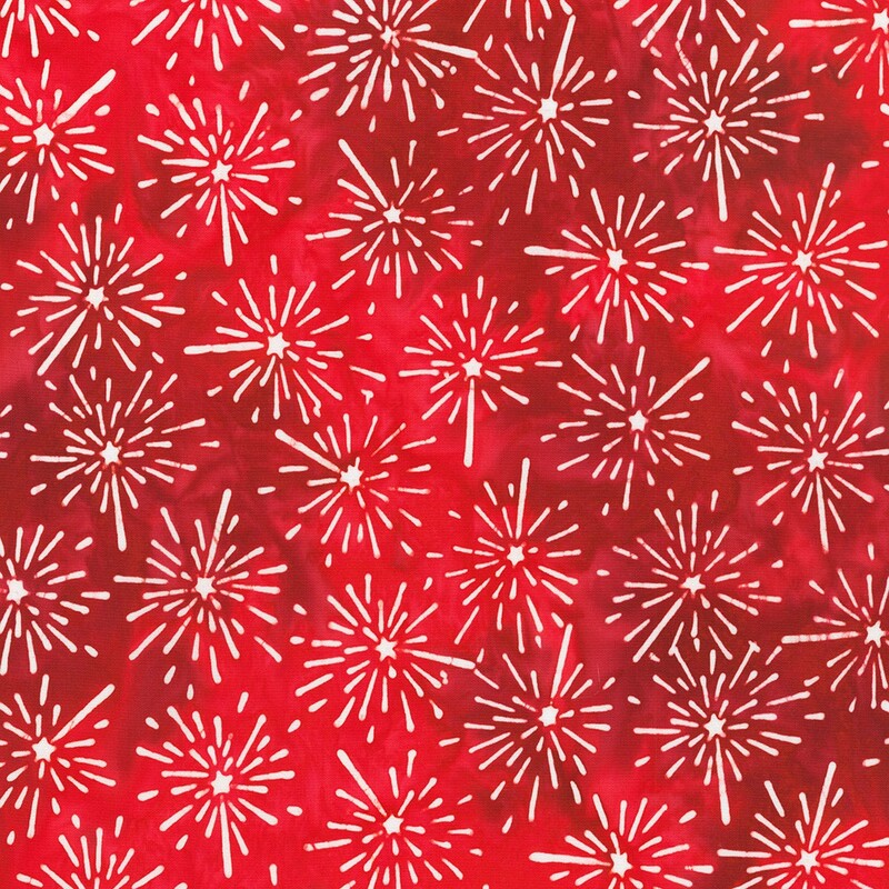 Red batik fabric with a white firework pattern 