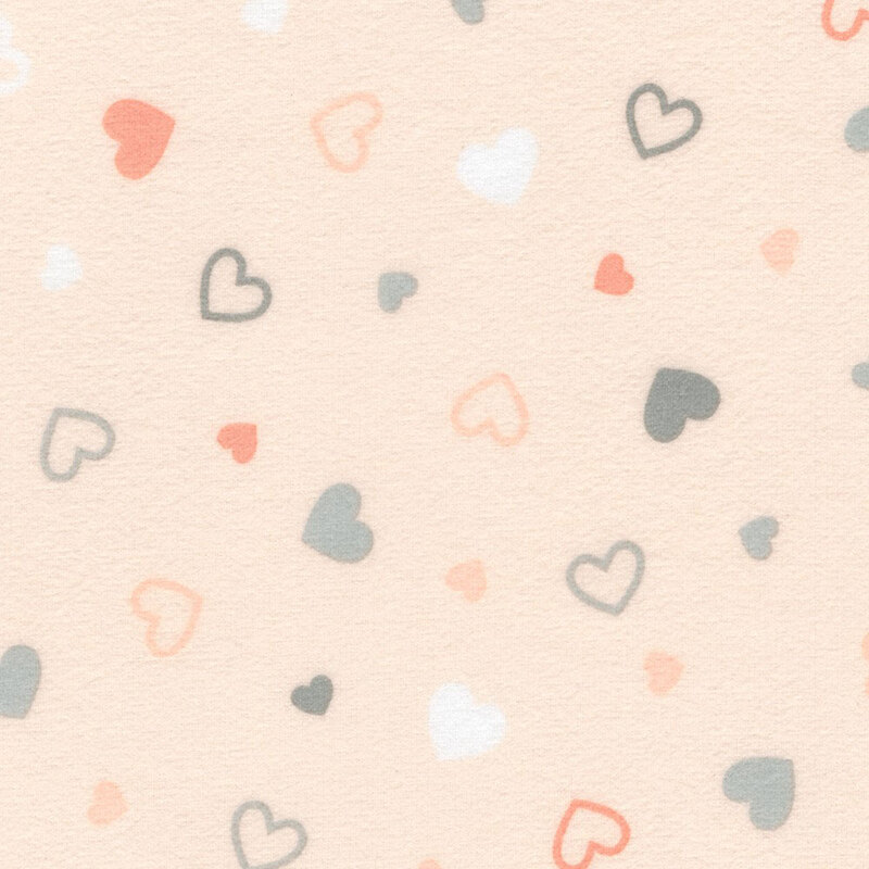 Pastel peach fabric tossed with colored hearts