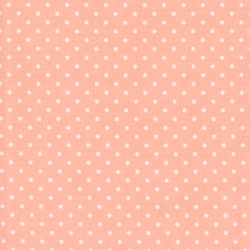 Peach fabric with white polka dots
