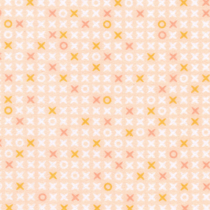 Pastel peach fabric scattered with x's and o's
