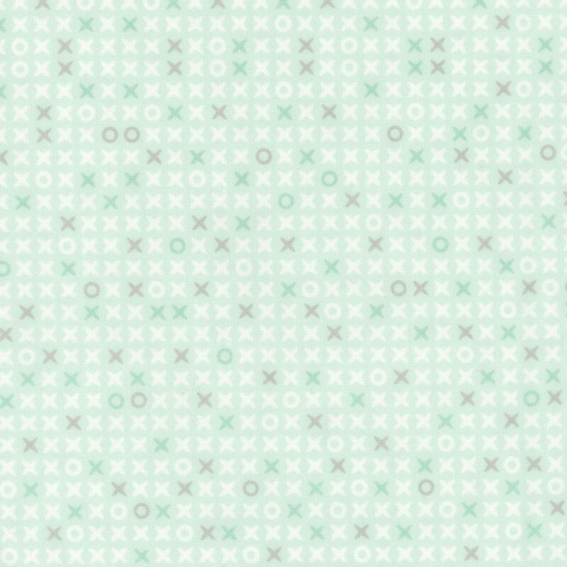 Pastel mint green fabric scattered with x's and o's