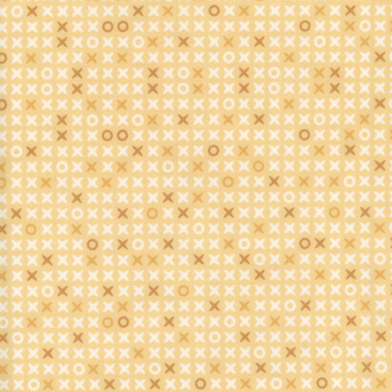 Pastel golden yellow fabric scattered with x's and o's
