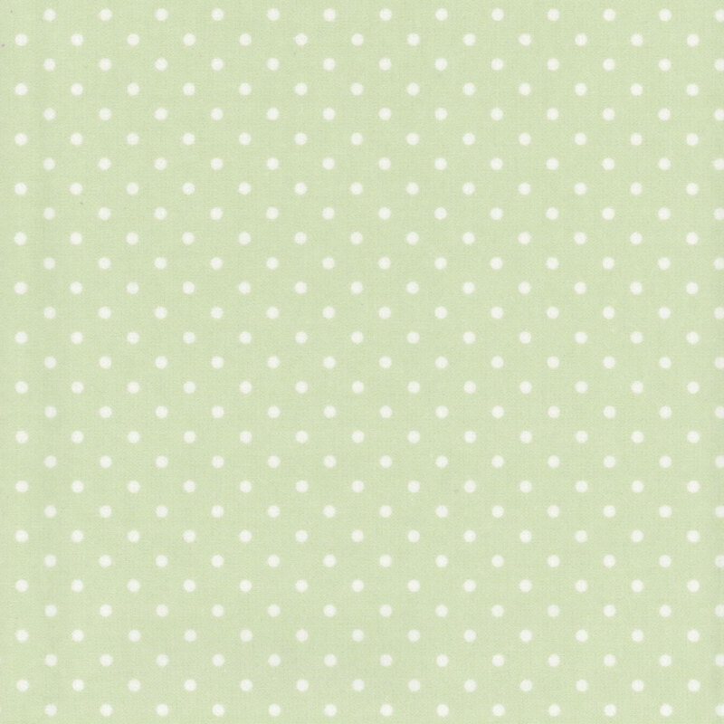 Pastel green fabric with white polka dots