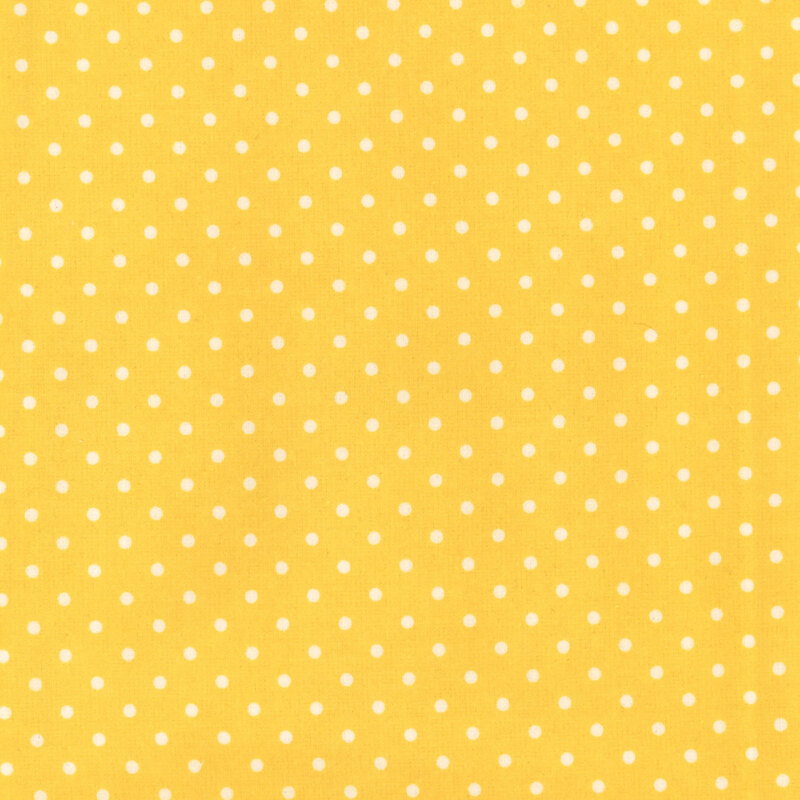 yellow fabric with white polka dots