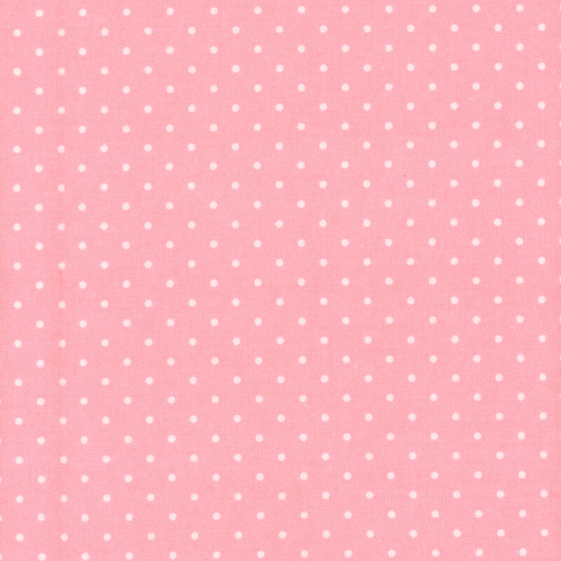 Pastel pink fabric with white polka dots
