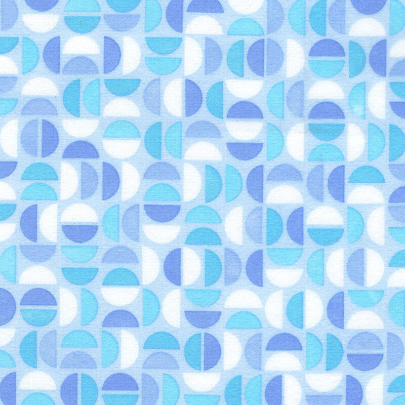 Blue fabric featuring a geometric design of half circles in white, and shades of blue