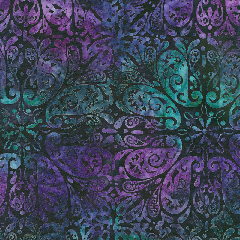 Dark green and purple mottled batik fabric with paisleys arranged in a repeated pattern