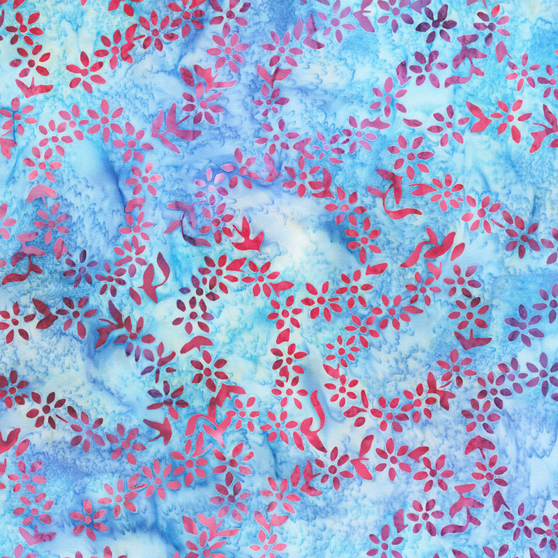 Blue mottled batik fabric with outlines of paisleys made of dark red florals