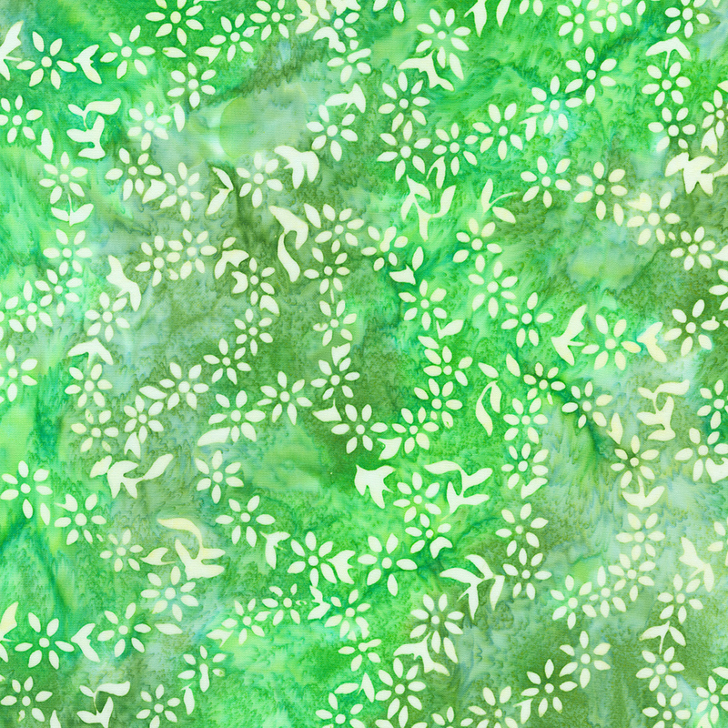 Green mottled batik fabric with paisley outlines made of small white florals throughout