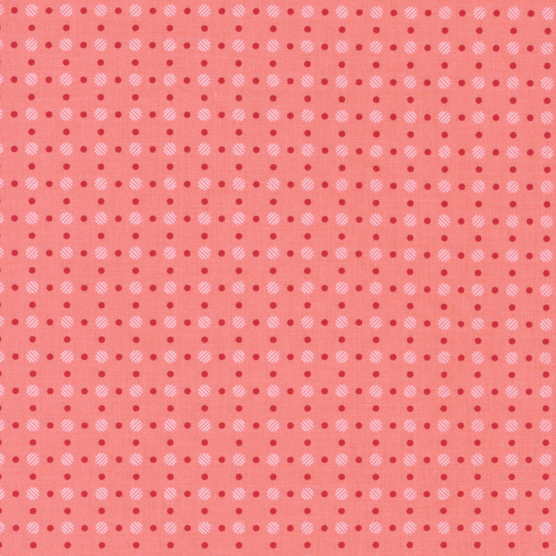 pink fabric with large white striped polka dots with smaller red dots between