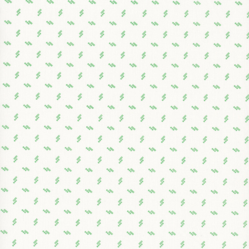 White fabric with green clusters of lines and squares.