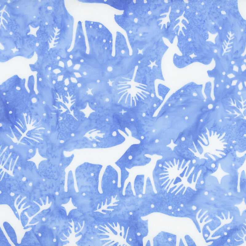 Light blue mottled batik fabric with white silhouettes of deer, pine sprigs, stars, and snowflakes