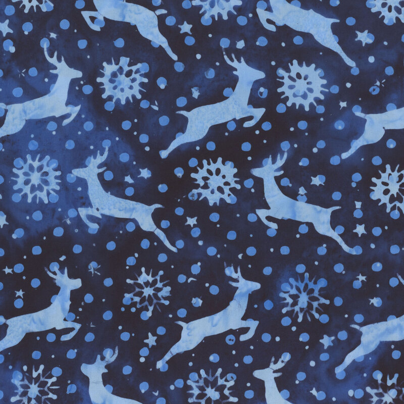 Dark blue navy batik with light blue silhouettes of dashing deer, polka dots, and snowflakes