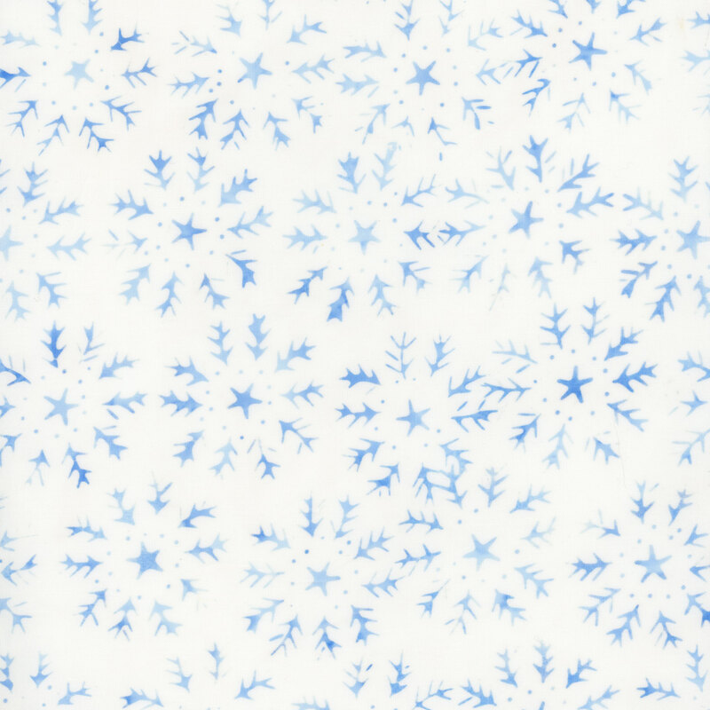 White batik fabric with silhouettes of snowflakes with stars in the center of each