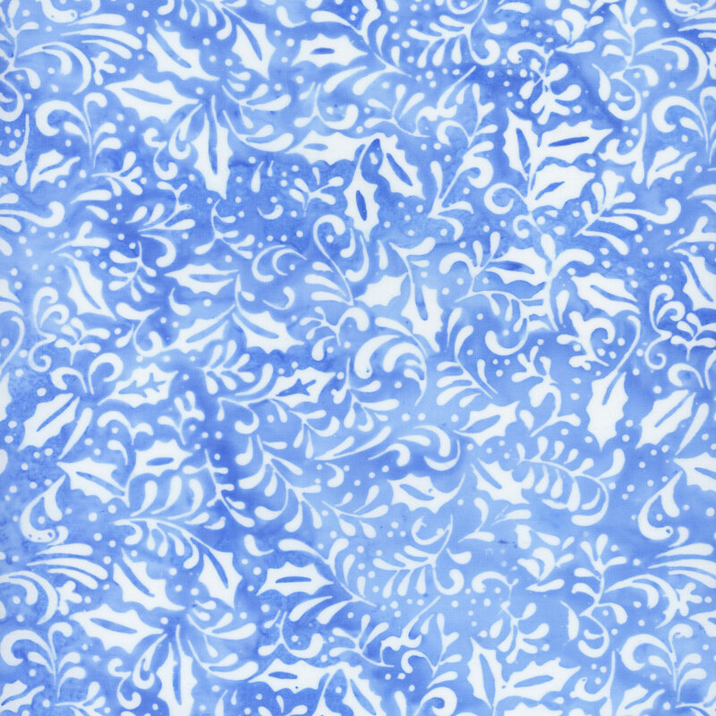 Light blue mottled batik fabric with white silhouettes of swirling vines and holly leaves throughout
