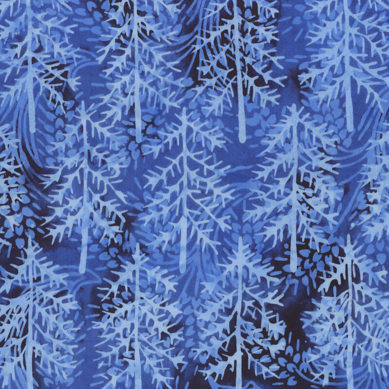 Dark blue mottled batik with lighter blue silhouettes of pine trees throughout