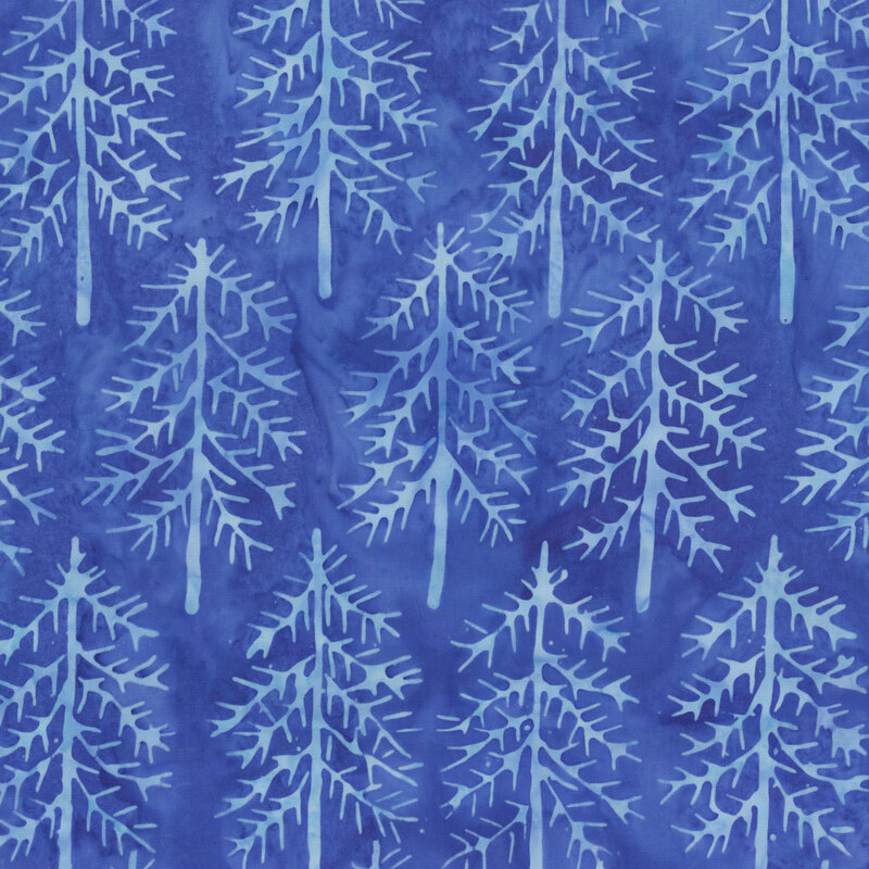 Medium blue tonal batik with silhouettes of lighter blue pine trees throughout