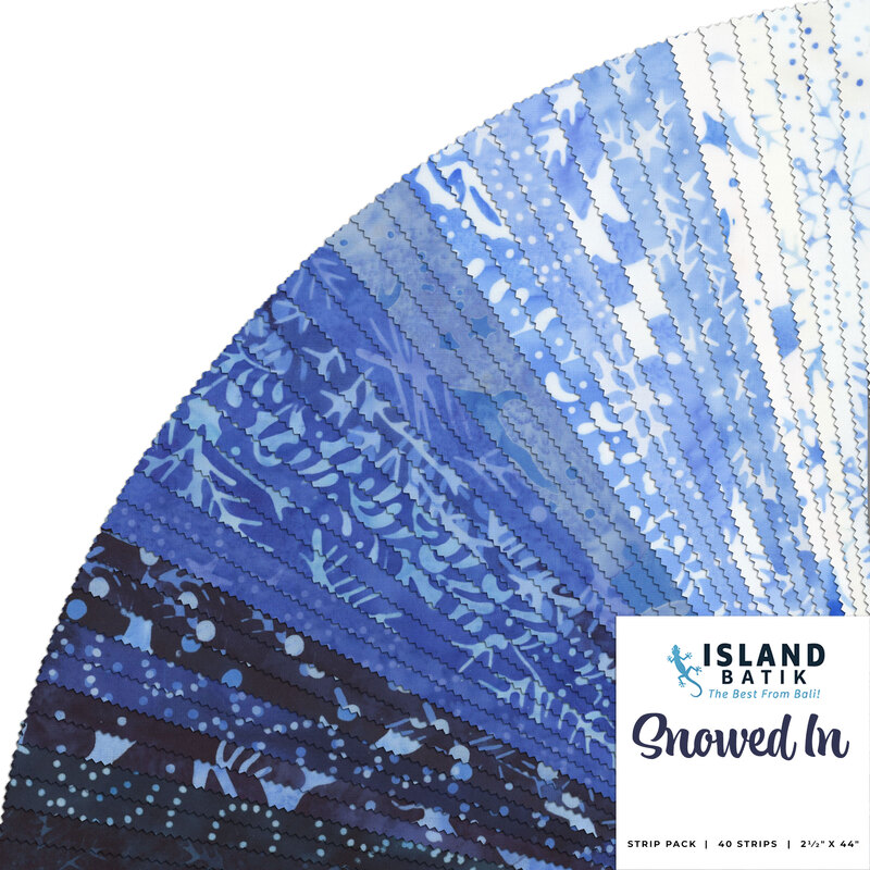 A fanned collage of blue and white mottled batik fabrics with winter motifs