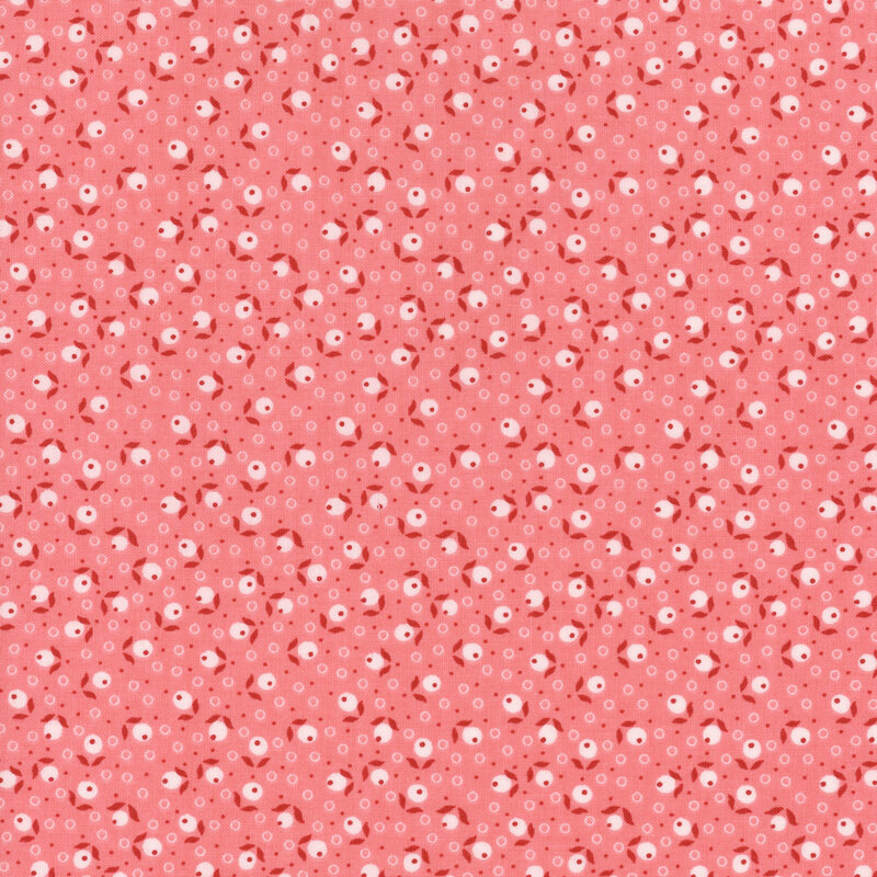 Pink fabric tossed with leaves, berries, and circle dots