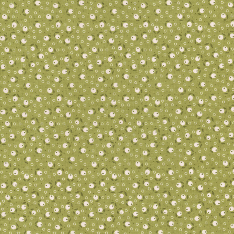 Green fabric tossed with leaves, berries, and circle dots